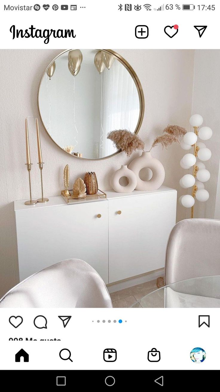 an instagram photo of a white dresser with gold accents