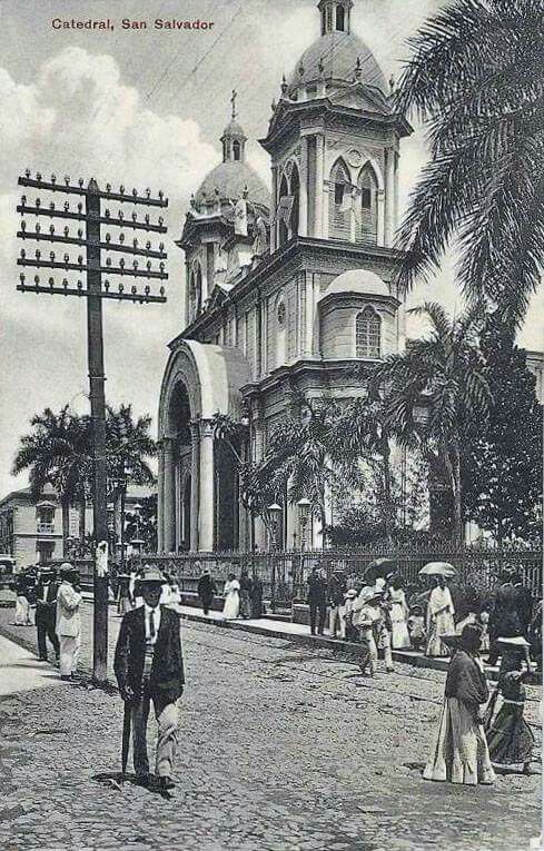 an old black and white photo of people walking in front of a church