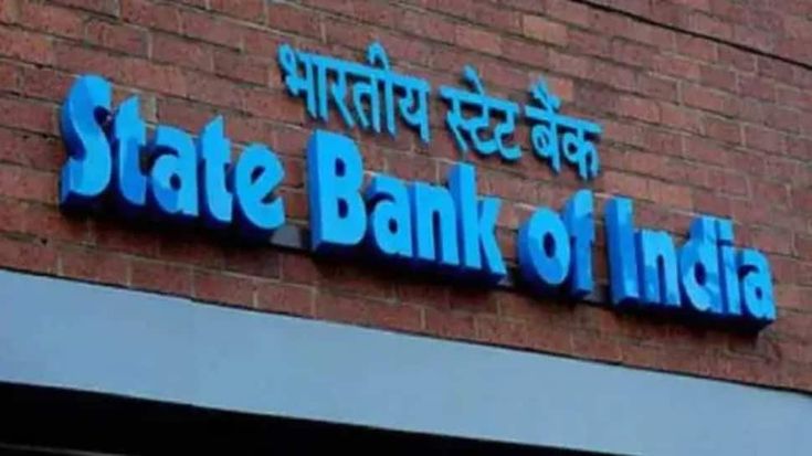 state bank of india sign on the side of a red brick building with blue lettering