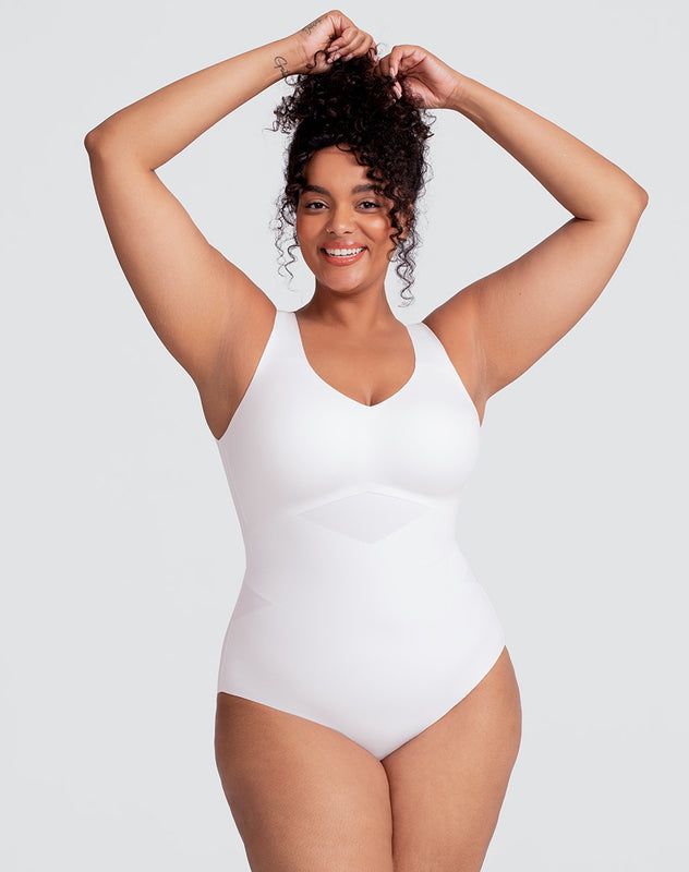 Honeylove's LiftWear Tank Bodysuit is powerful and versatile. This Bodysuit features 360° bonded compression to sculpt your midsection, underwire-free bust support so you can ditch your bra, and wide straps that won't dig in. This garment features an adjustable gusset that anchors the garment to ensure it always stays tucked in. Wear as an undergarment or a stylish top. Honeylove, Tank Bodysuit for Women in Astral (White), Size: 2X Supportive Full Coverage Shapewear With Built-in Padding, White Fitted Shapewear Bodysuit, White Seamless Shapewear Bodysuit, White Underwire Bodysuit With Built-in Bra, White Fitted Swimwear Shapewear, White Fitted Shapewear Swimwear, Fitted White Shapewear Swimwear, Elegant White Smoothing Shapewear, White Shaping Bodysuit With Built-in Bra