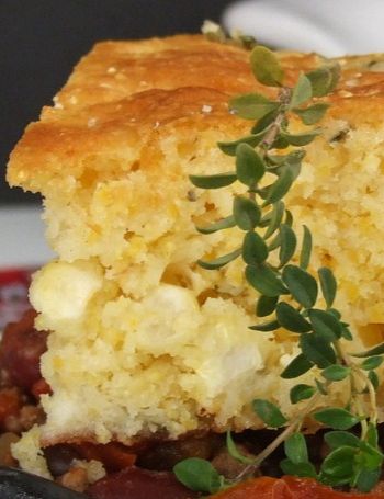 a close up of a plate of food with meat and bread on it's side