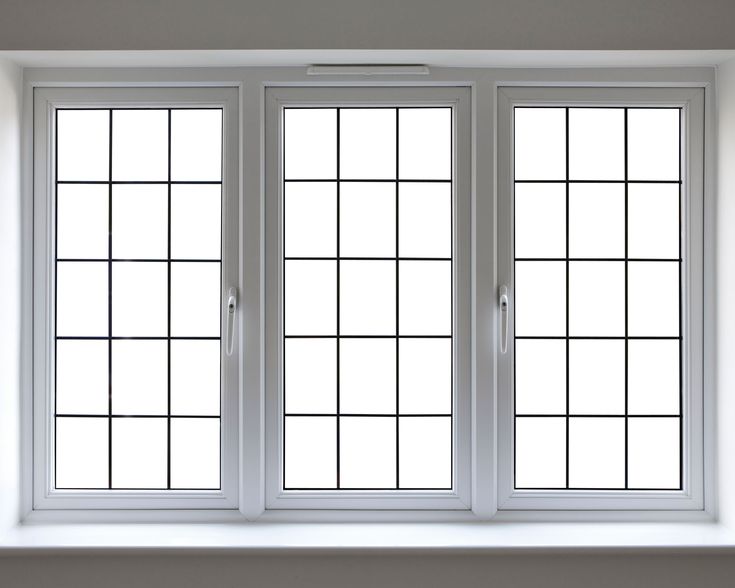 three windows in a room with white walls