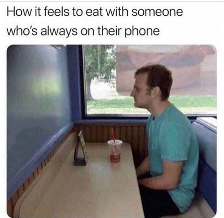 a man sitting at a table with a drink in front of him and the caption reads, what it feels like to eat with someone who is always on their phone