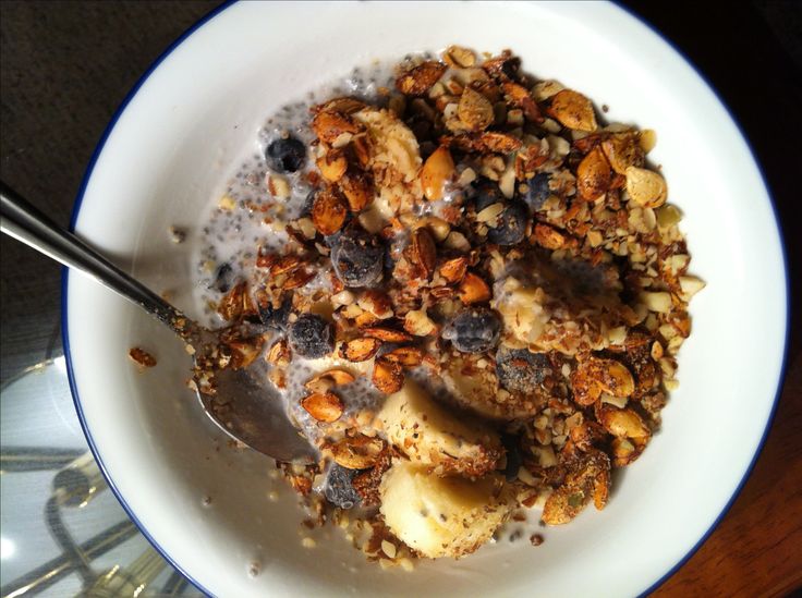 a bowl filled with oatmeal and nuts on top of a table