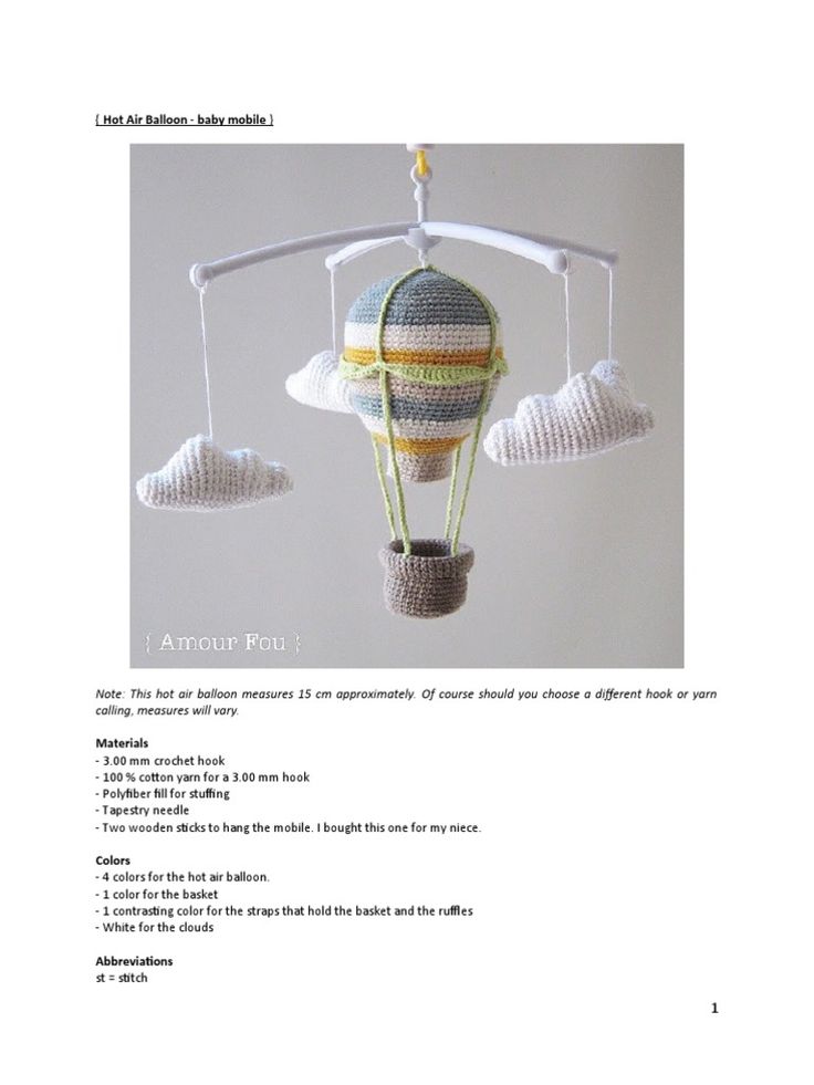 a crocheted hot air balloon is hanging from a hook on a white background