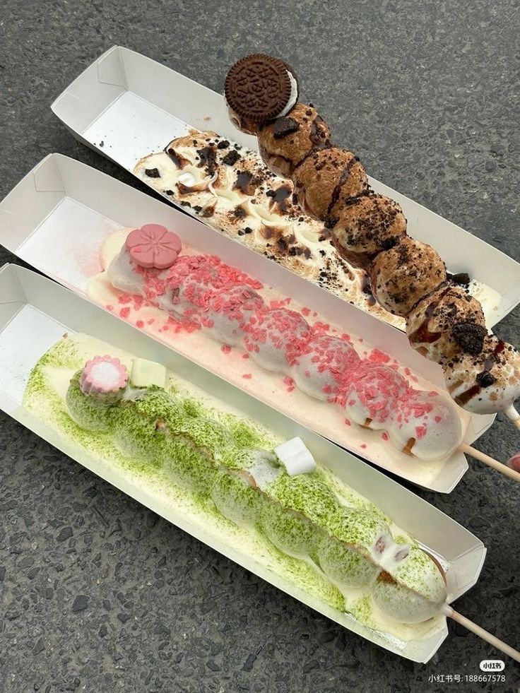 three different desserts are on display in white trays