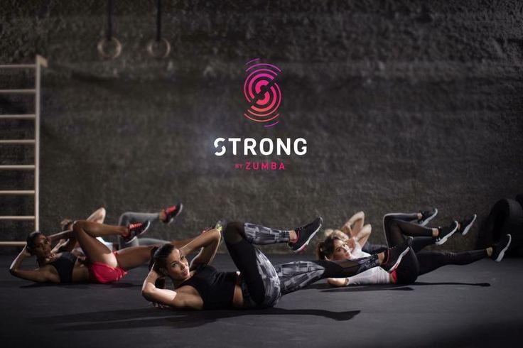 a group of people laying on the ground doing stretching exercises