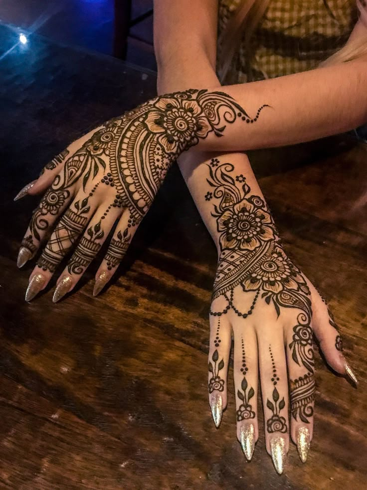 a woman's hand with henna tattoos on it and the words find your next design at