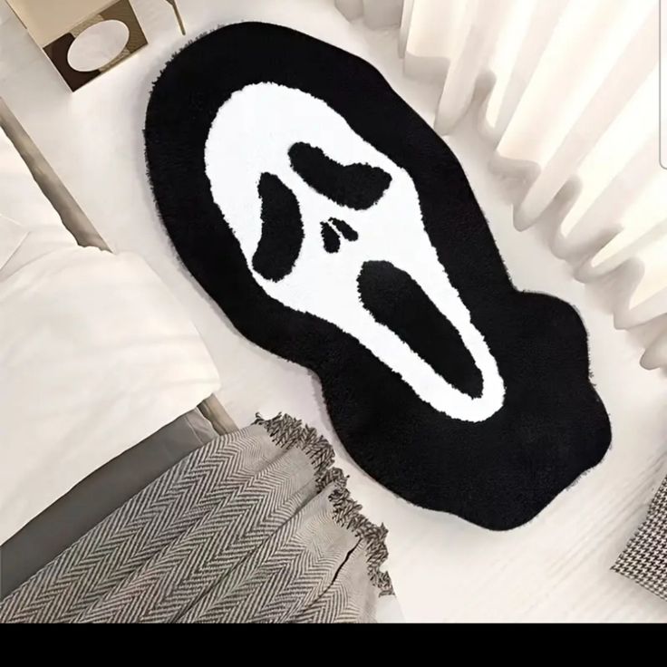 a black and white rug with a face on it