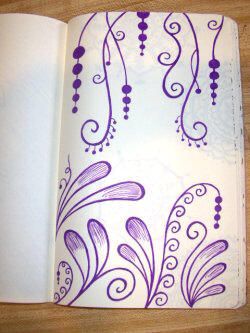 an open notebook with purple designs on it