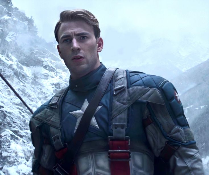 captain america the winter soldier is standing in front of a mountain with snow on it