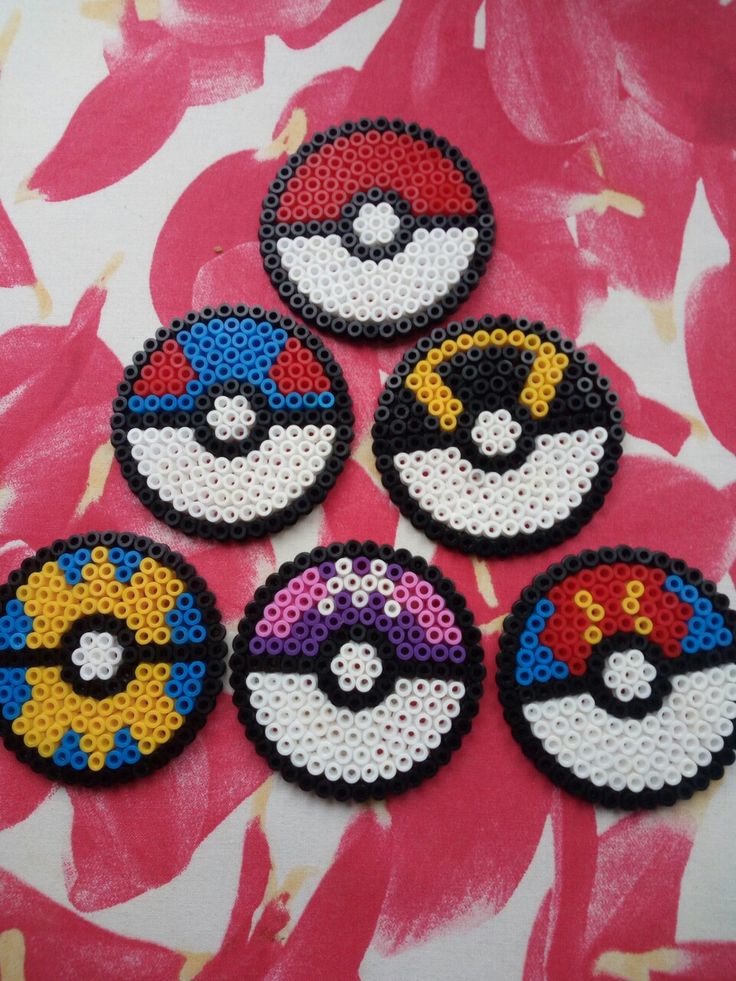 four different types of sequinized pokemon coasters on a pink flowered surface