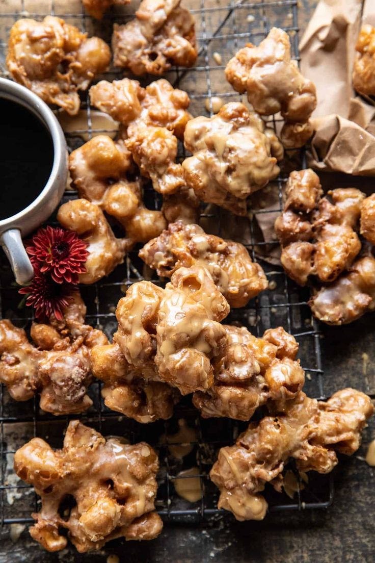 some food is on a cooling rack next to a cup of coffee