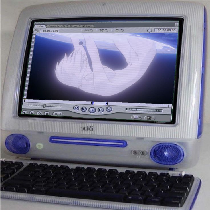 an old desktop computer sitting on top of a white table next to a keyboard and mouse