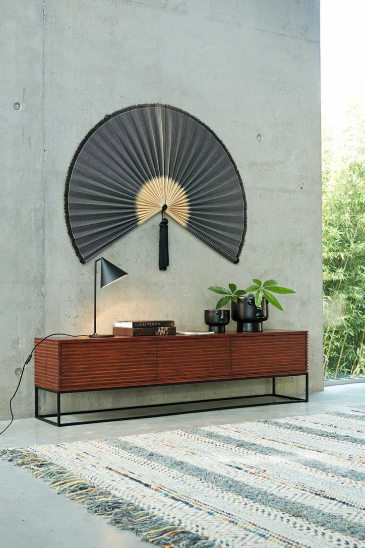 a table with a fan on it next to a wall