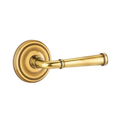 an antique brass door handle on a white background