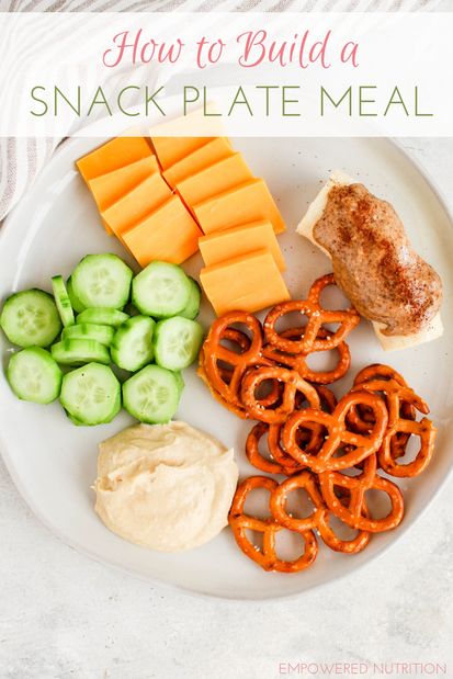 a plate with crackers, pretzels and cheese on it that says how to build a snack plate meal