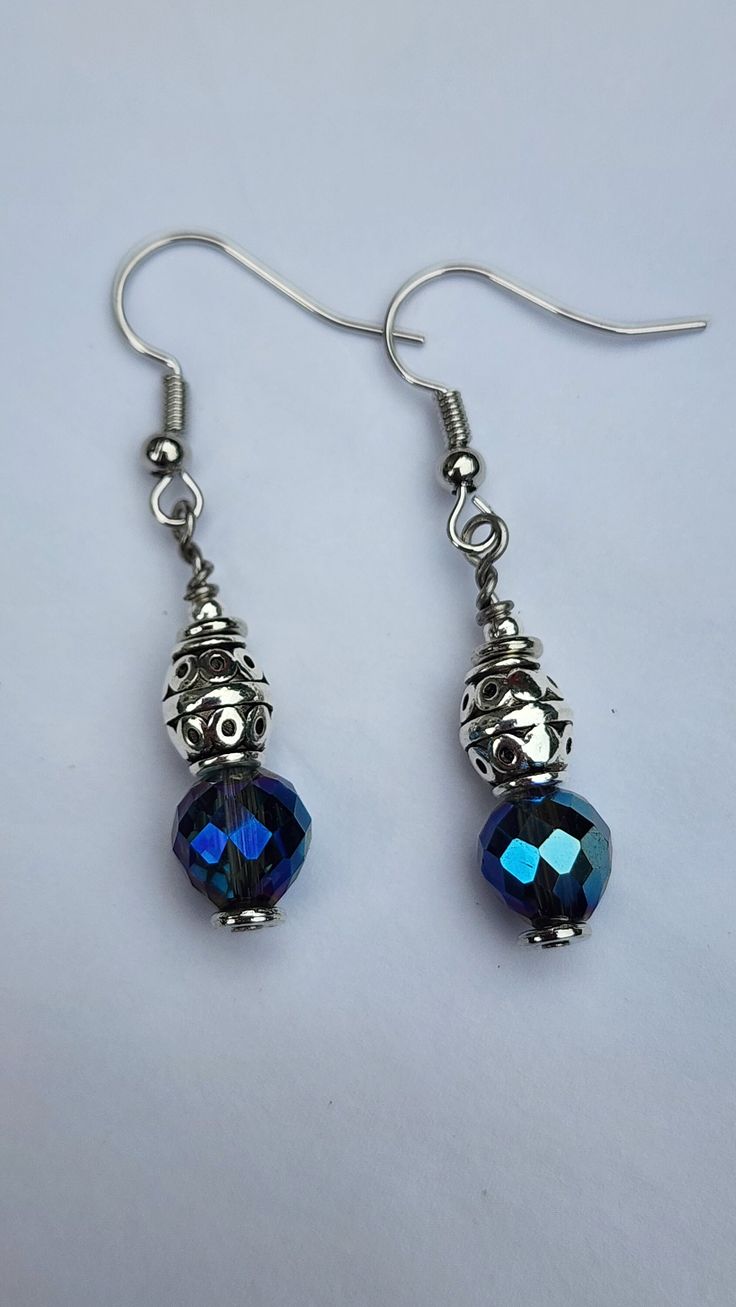 pair of blue crystal earrings on white background