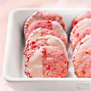 red velvet donuts with white frosting in a pink dish