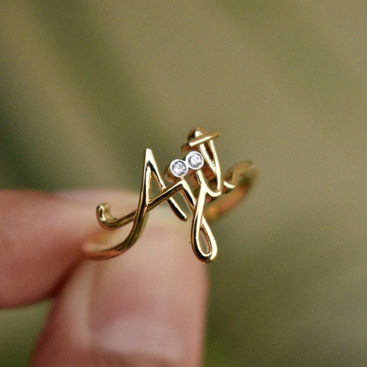 "Beautiful handcrafted 14k Solid Gold name ring. This lovely custom made ring is a perfect accessory to own or gift - for your wife, best friends, brothers, sisters and all of your loved ones :) Important dates/coordinates can also be made. We will send a drawing before starting the manufacturing process so you know what it will look like. * Diamond Color-Clarity Grade : H-I, Vs-Si * Gold - 14k Solid Gold SENDING AS A GIFT We would be happy to send your gift directly to the recipient, including Spiritual 14k Gold Engraved Wedding Ring, Diamond Engraved Ring With Initials For Gift, Diamond Engraved Ring With Initials As Gift, Custom Name Yellow Gold Jewelry For Promise, Yellow Gold Initial Ring For Mother's Day Wedding, Yellow Gold Initial Ring For Wedding On Mother's Day, Personalized Diamond Initial Ring For Wedding, Diamond Engraved Ring For Gift, Gift White Gold Diamond Ring With Initials