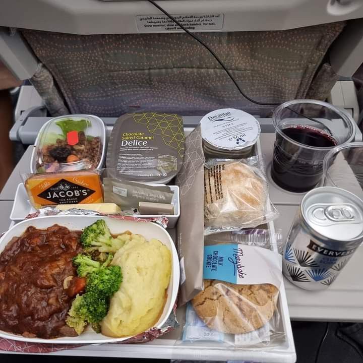 an airplane tray with food and drinks on it