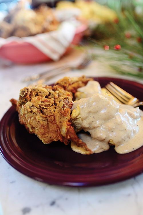 a plate topped with fried chicken covered in gravy