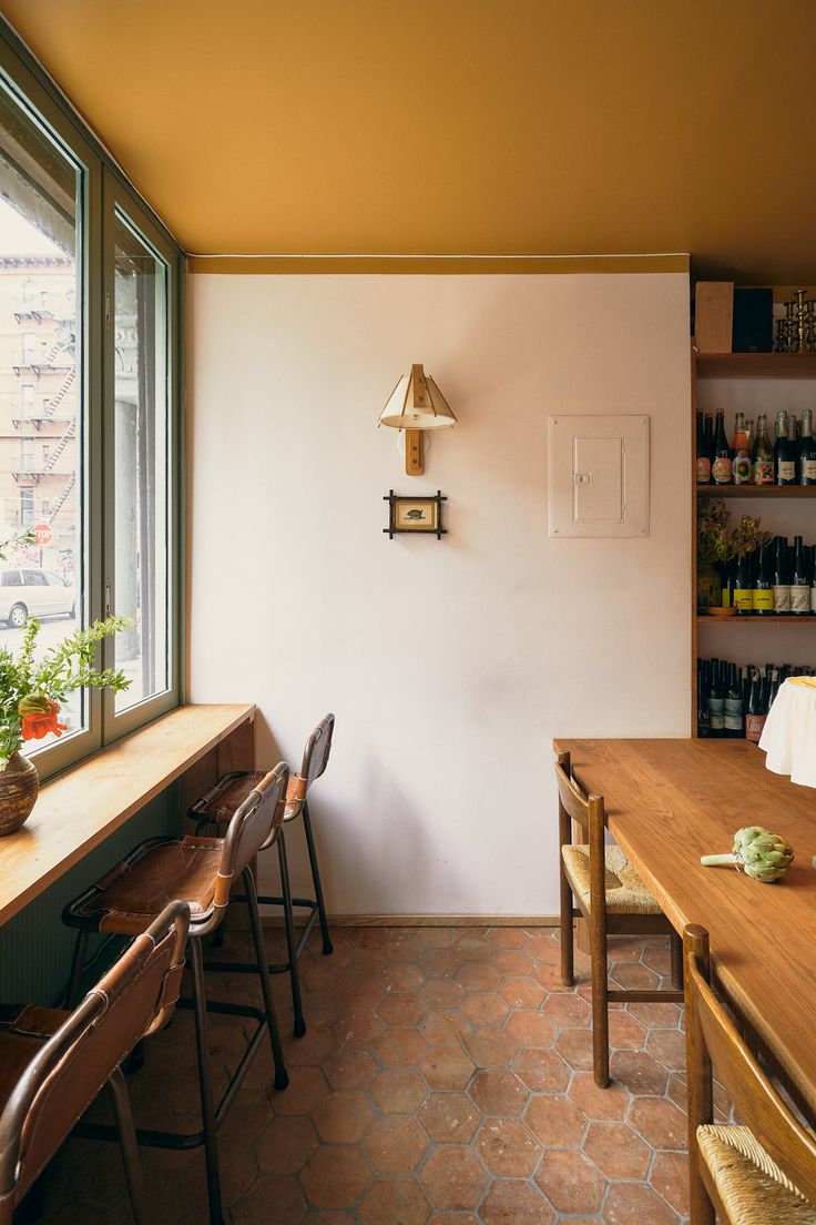 an empty room with wooden tables and chairs