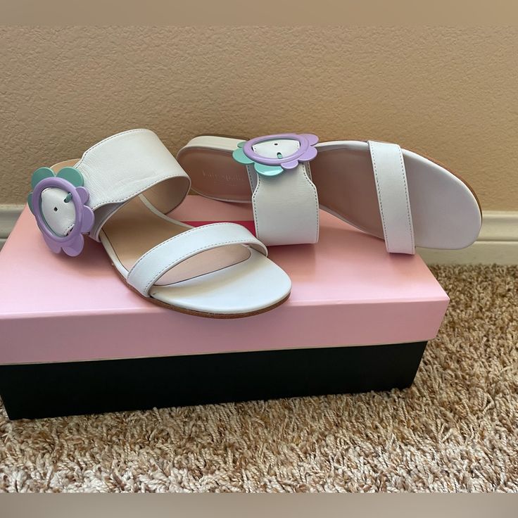 Earl Kate Spade Sandals. Color White With Beautiful Flower Buckle Detail In Lavender And Mint Color. Leather. New Never Worn. Cute White Flat Heel Sandals, Cute Purple Sandals For Spring, Cute Purple Open Toe Sandals, Kate Spade Synthetic Sandals For Spring, Kate Spade Open Toe Sandals For Spring, Kate Spade Spring Open Toe Sandals, Kate Spade Trendy Spring Sandals, Trendy Kate Spade Sandals For Spring, Trendy Kate Spade Spring Sandals