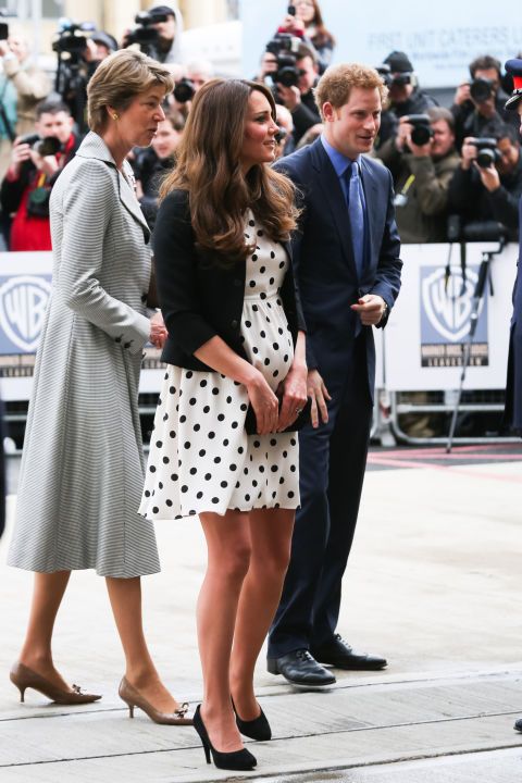 the duke and princess of cambridge are standing next to each other in front of photographers