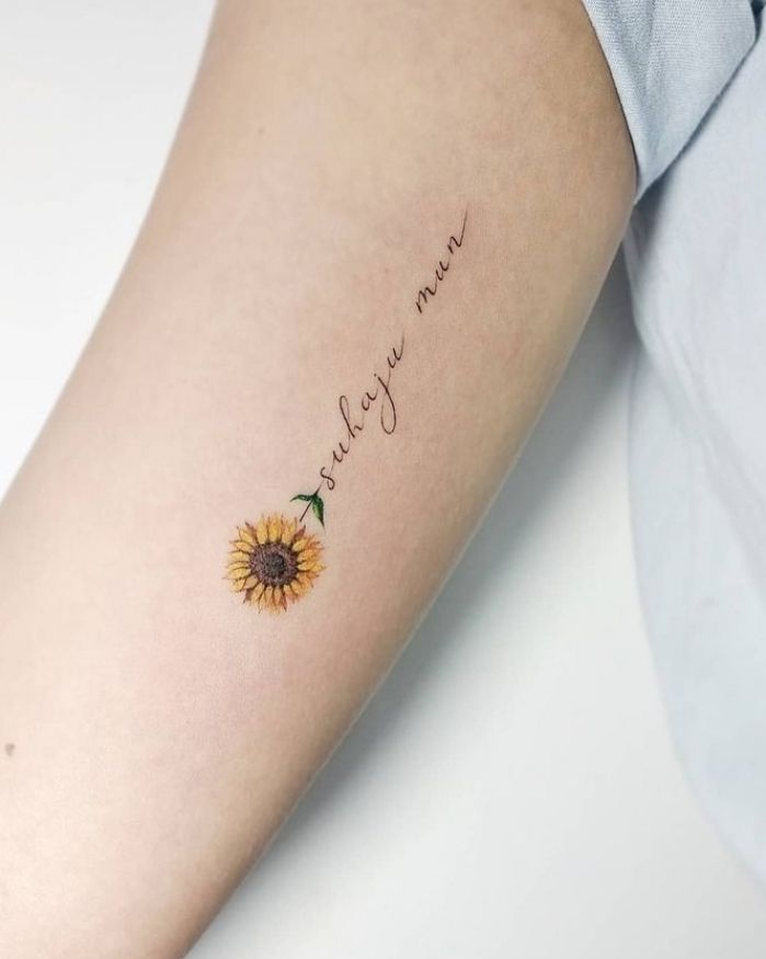 a woman's arm with a sunflower tattoo that says, i love you mom