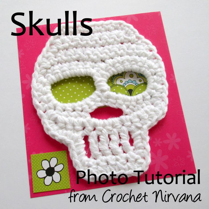 a crocheted skull is on top of a pink card with the words skulls