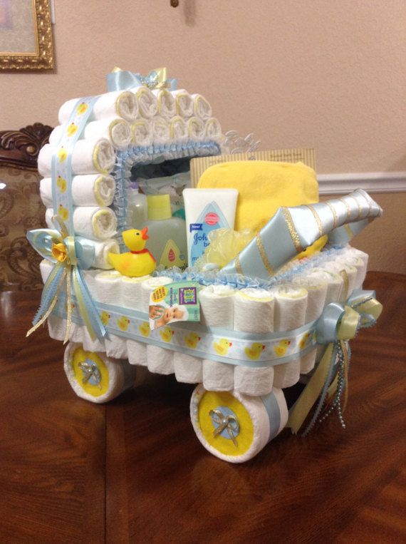 a baby carriage that is on top of a table with towels and other items in it