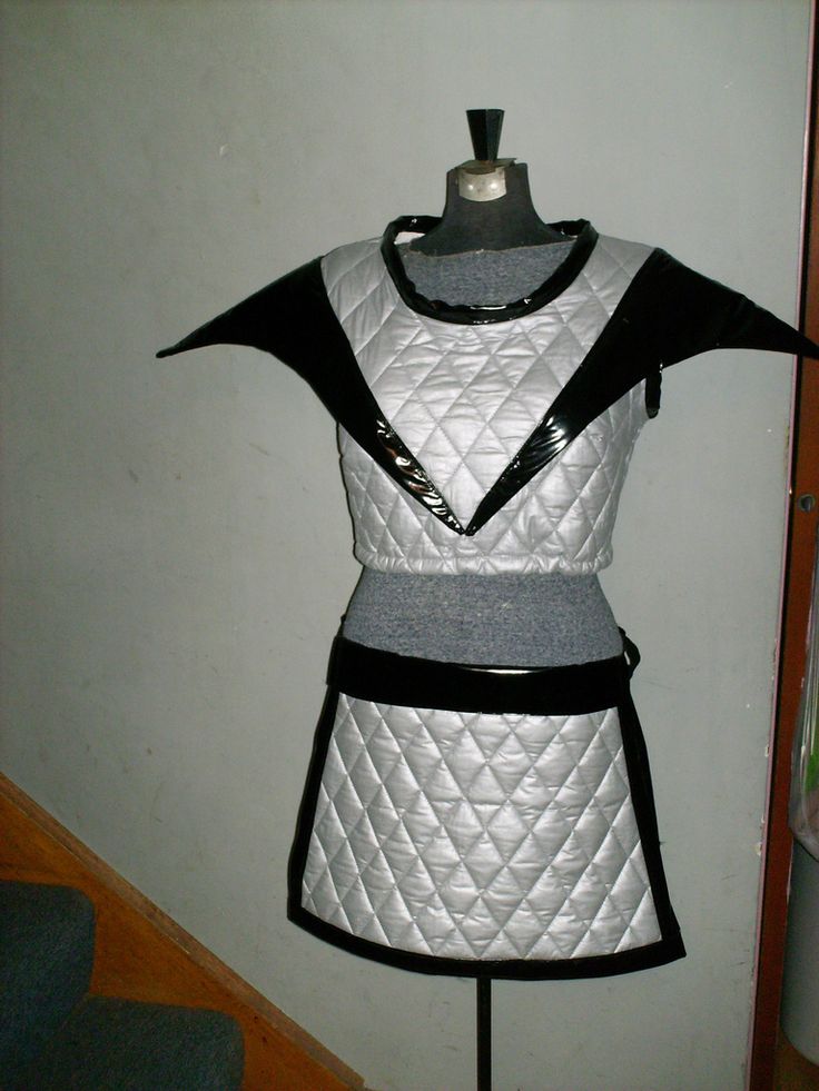 a mannequin is dressed in silver and black