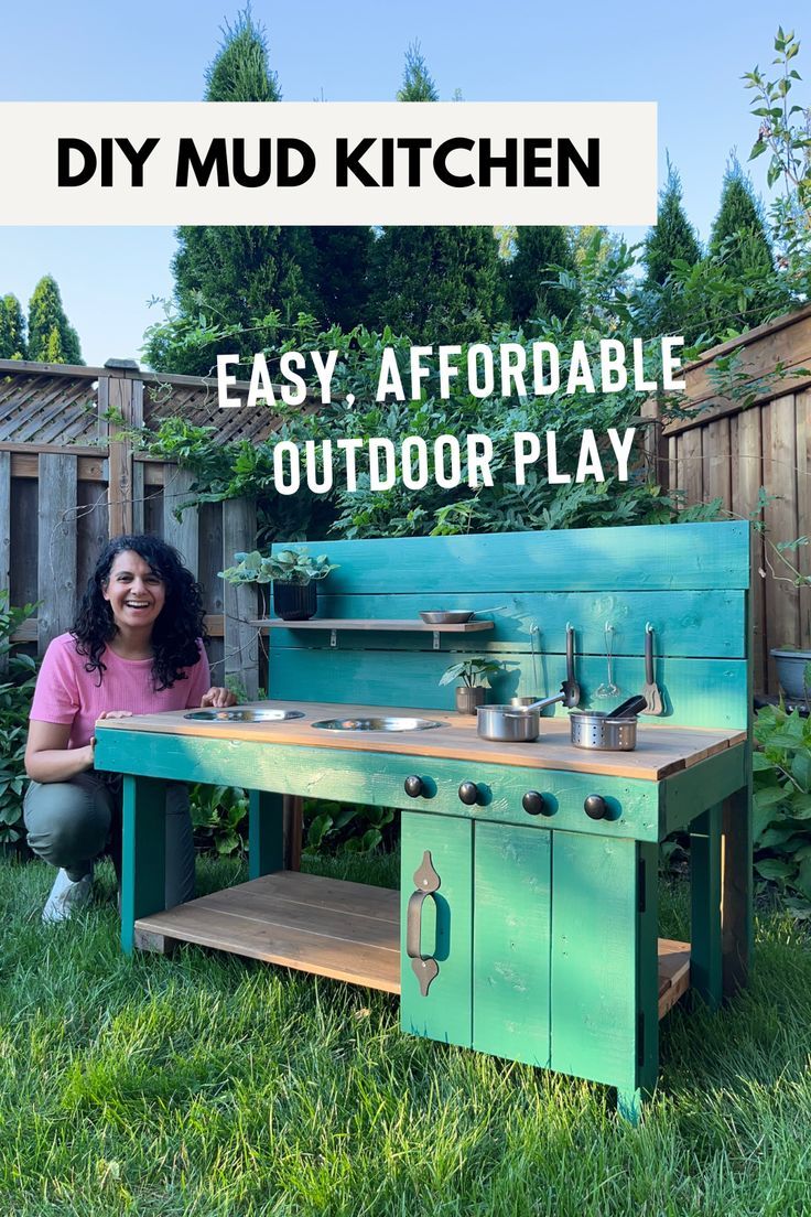 a woman sitting in the grass next to an outdoor play kitchen with words overlay that says diy mud kitchen