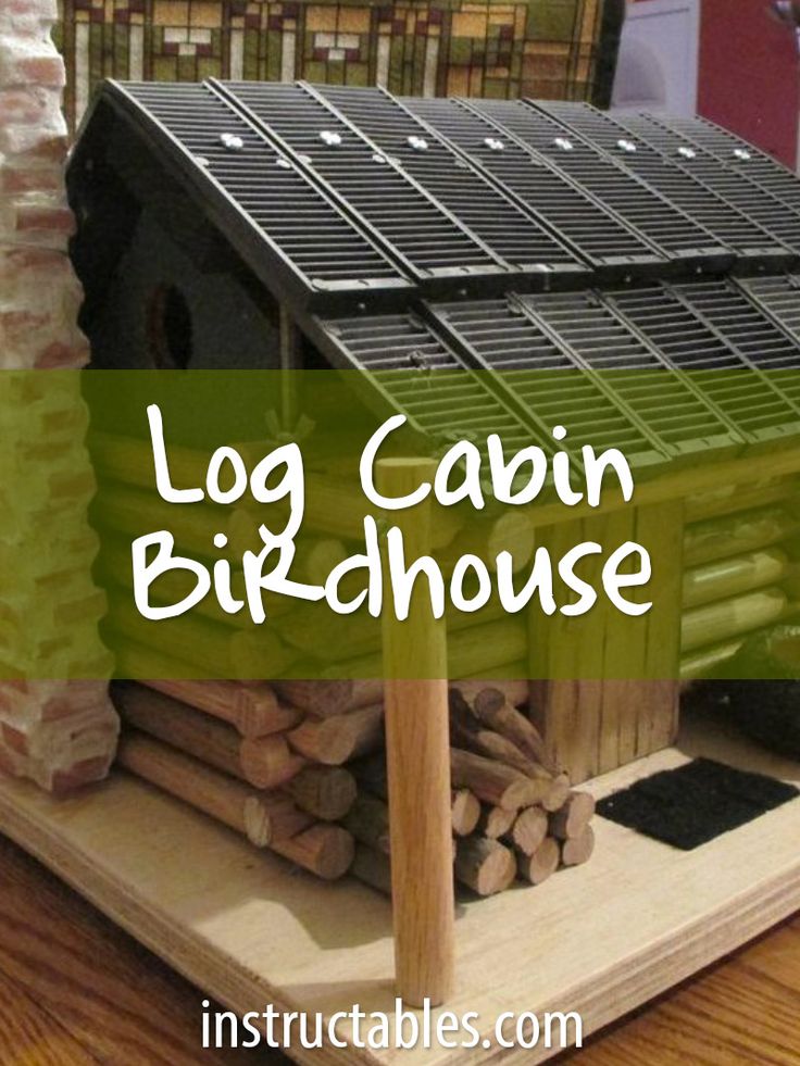 a small house made out of logs with the words log cabin birdhouse