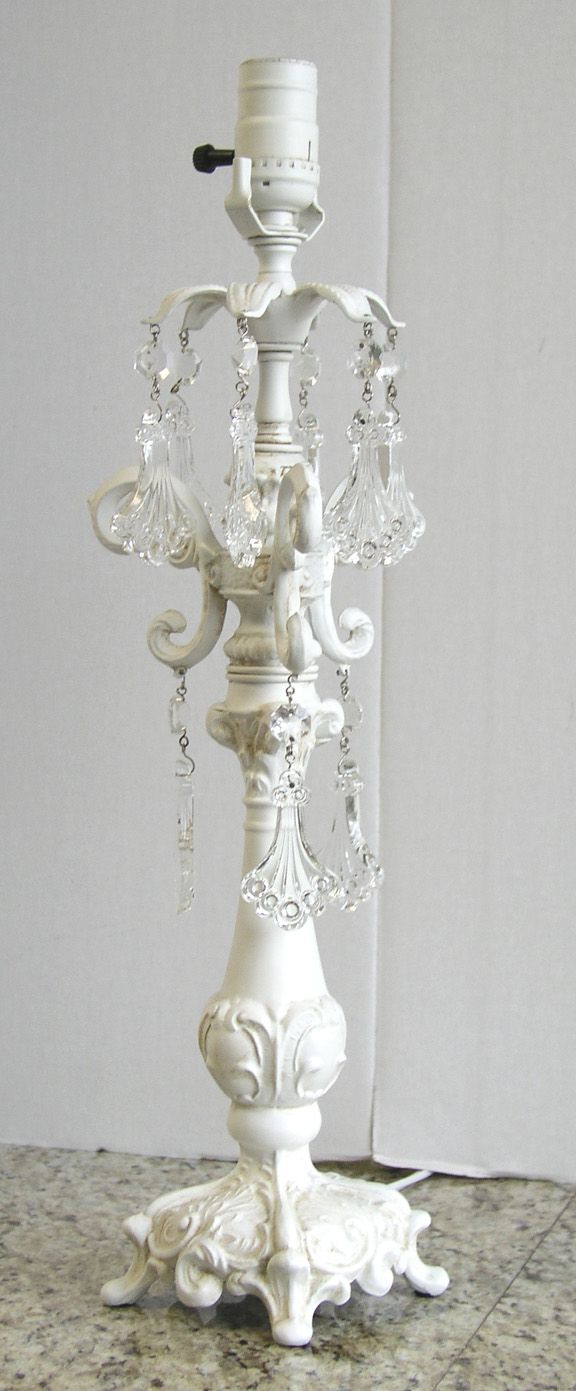 a white candelabra with crystal chandeliers on it's sides