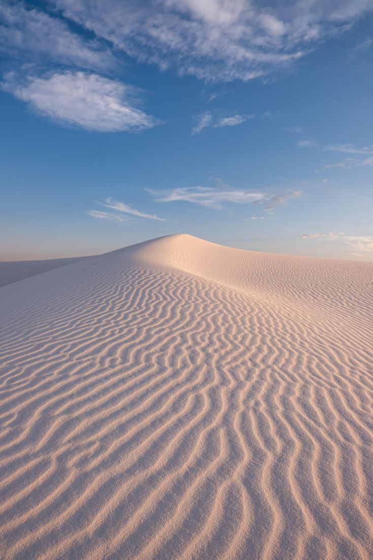 the sand dunes are almost completely covered in ripples