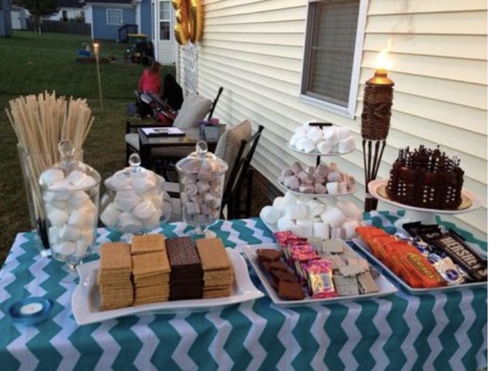 a table topped with lots of desserts on top of a blue and white table cloth