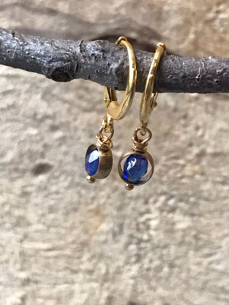 Lovely tiny gold hoop earrings with a touch of sapphire blue dangling ever so slightly. The Huggie hoops are sterling silver and plated with gold. From these tiny hoops hangs a sapphire blue vintage glass bead inside a small brass hoop. The total length of these earrings is less than an inch, making them great every day earrings. The lever back makes them easy to use... another bonus for everyday wear. All orders are shipped in recycled packaging. Blue Small Hoop Huggie Earrings, Dainty Gold Plated Nickel Free Huggie Earrings, Blue Hypoallergenic Small Hoop Jewelry, Hypoallergenic Blue Small Hoop Jewelry, Dainty Nickel-free Drop Huggie Earrings, Blue Hoop Huggie Earrings Gift, Blue Huggie Hoop Earrings For Gift, Blue Huggie Hoop Earrings As Gift, Blue Hypoallergenic Small Hoop Huggie Earrings