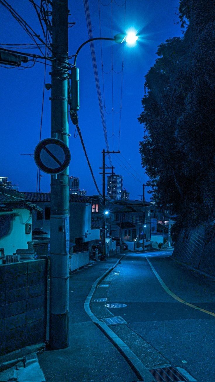 an empty street at night with no cars on it