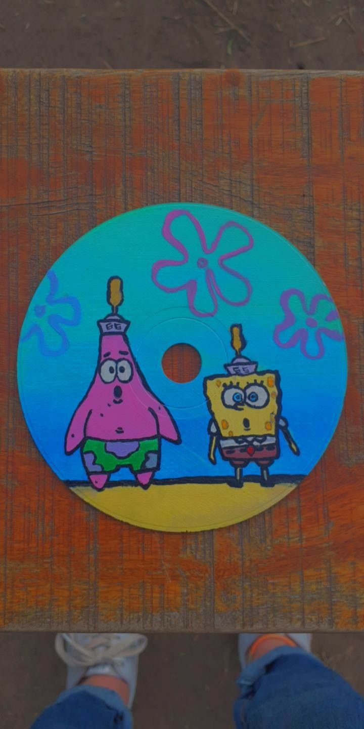 a person standing next to a cartoon disc