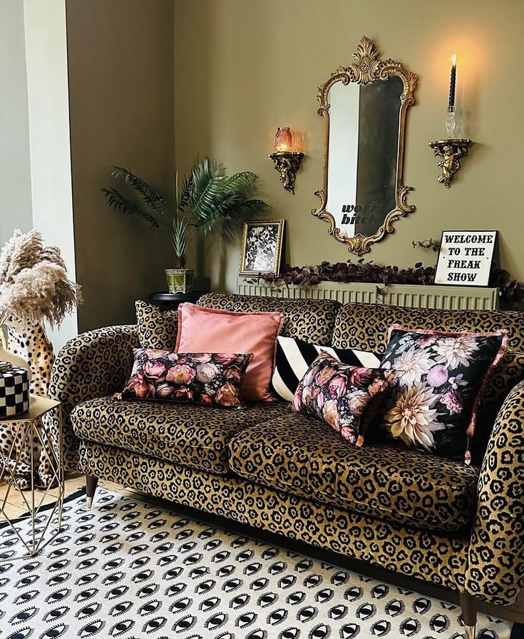 a living room filled with lots of furniture next to a wall mounted mirror on the wall