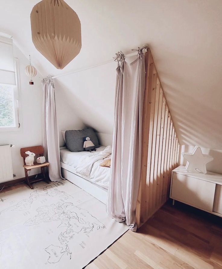 a bedroom with white walls and wooden flooring next to a bed in the corner