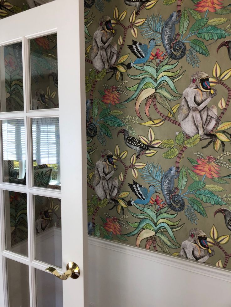 a wallpapered room with an open glass door