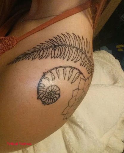 a woman's stomach with an eye tattoo on it