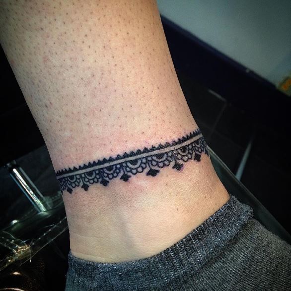 a woman's foot with a small tattoo on the left side of her ankle