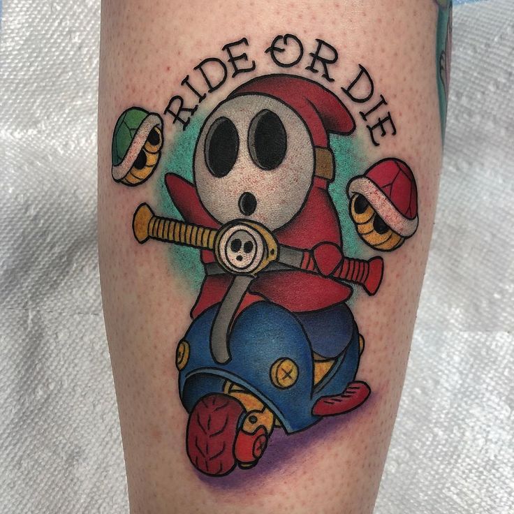 a person with a tattoo on their leg that reads, ride or die and is riding a scooter