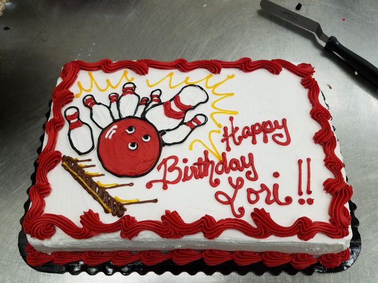 a birthday cake with a bowling ball and skis on it that says happy birthday to you