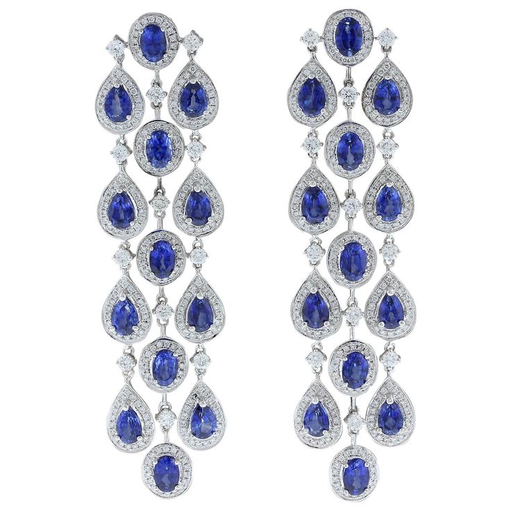 Three chandelier drops of 15.27 carats oval and pear cut blue sapphires adorn this pair of dancing earrings. Each of the deep ocean blue sapphires are haloed and linked by 4.36 carts of VS quality colorless diamonds. The delicate rainfall style of this pair of earrings set in 18K white gold is one to last an eternity. Earring Length: 3.00 inches Earring Width: 1.00 inch Sapphire Earrings Drop, The Deep Ocean, Blue Jewellery, Dance Earrings, Blue Sapphire Jewelry, Gold Chandelier Earrings, Bridal Diamond Jewellery, Antique Jewelry Indian, Deep Ocean