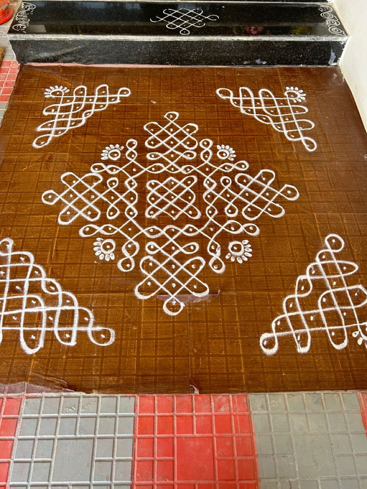 a brown and white rug sitting on top of a tiled floor